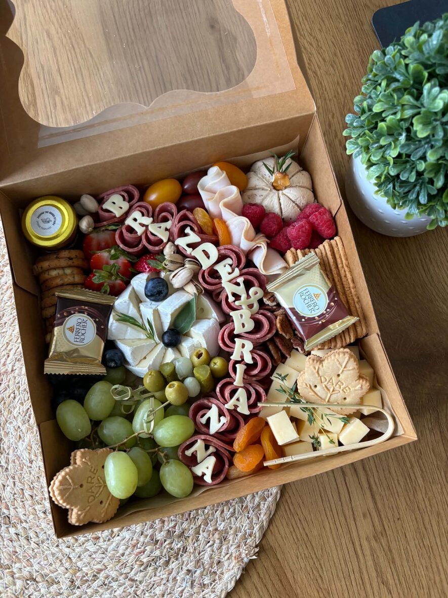 Large grazing box with a name spelled in cheese letters, brie, halal charcuterie roses, grapes and crackers