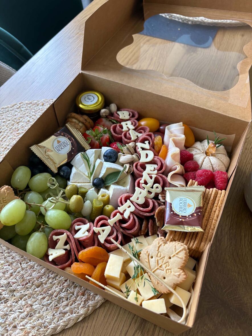Large grazing box overhead with brie, halal cured meats, olives, dried apricots and berries