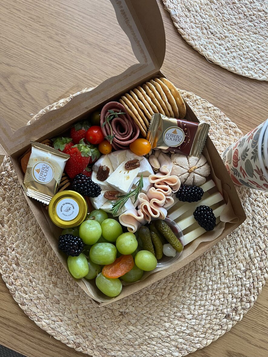 Medium grazing box overhead with a full spread of cheese, cured meats, fruit and crackers