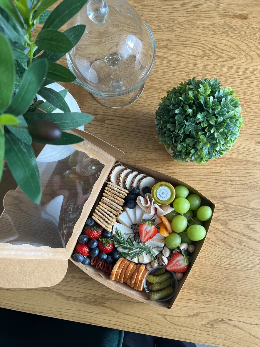 Medium grazing box overhead with cheese, cured meats, berries and crackers — charcuterie box Ottawa